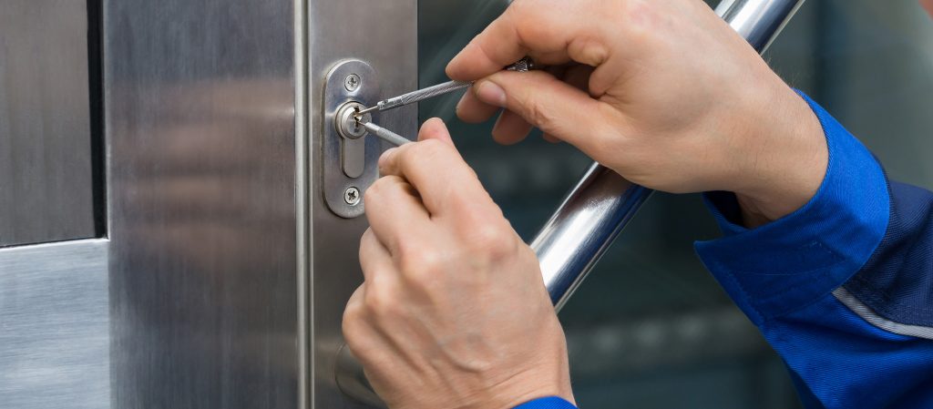 Close-up of a locksmith working on a door lock